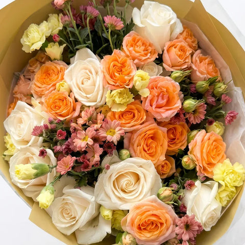 Peach Garden Bouquet with peach, orange, ivory, blush, and green flowers by Florent Floral in Newmarket