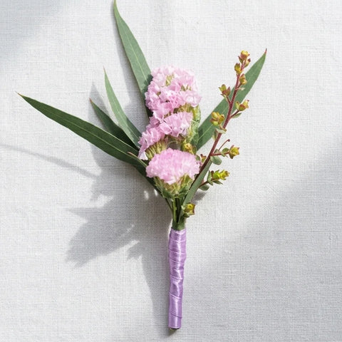 Pink Statice Boutonniere by Florent Floral with pink statice with greenery and small accent stems for prom in Newmarket.