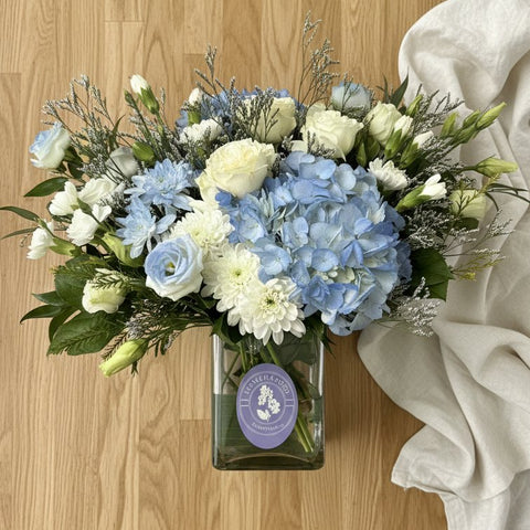 Blue and white sympathy flowers for funeral and condolence delivery in Newmarket Ontario