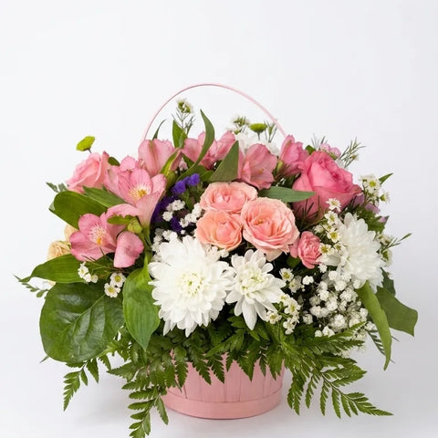 Pink spray roses, chrysanthemums, and alstroemeria in a round pink basket — Spring Bloom Basket by Florent Floral Newmarket