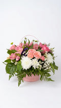 Pink spray roses, chrysanthemums, and alstroemeria in a round pink basket — Spring Bloom Basket by Florent Floral Newmarket