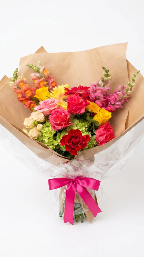 Citrus Rose Bouquet with orange, coral, hot pink, yellow, and green flowers by Florent Floral in Newmarket