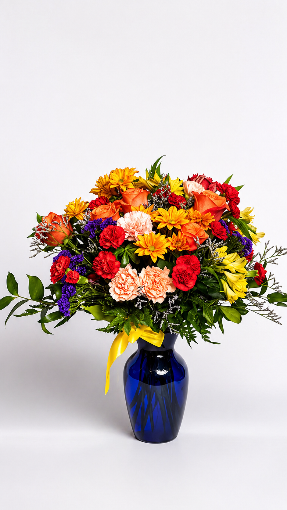 Colorful bouquet of flowers in a blue vase on a white background good for mother's day