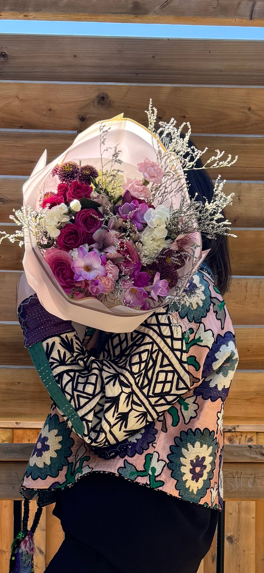 Person holding the Twilight Bloom Bouquet outdoors - a stunning purple and pink flower gift for Mother's Day delivery in Newmarket ON